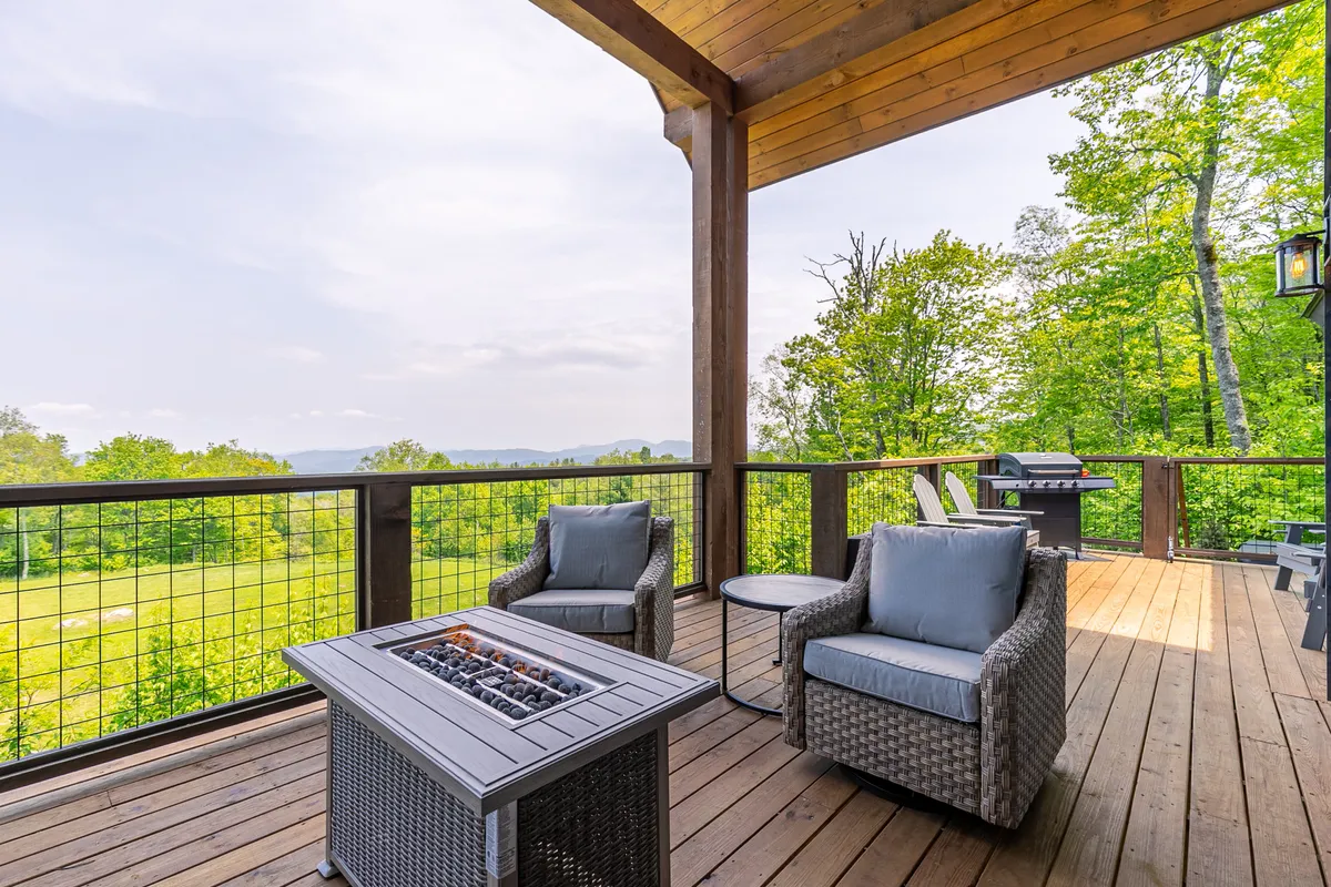 An inviting outdoor space featuring a fire pit surrounded by seating, set against lush green landscaping. The area is ideal for barbecues, socializing, and relaxing—embodying the tranquil moments guests can enjoy between adventures.